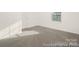 Bright and spacious bedroom with neutral carpet, ample natural light, and closet at 4044 Beacon Ave # 152, Monroe, NC 28110