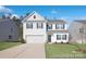 Charming two-story home with a manicured lawn, driveway, and a two car garage at 4044 Beacon Ave # 152, Monroe, NC 28110