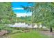 Scenic backyard view of lawn, wooden fence, and lake at 5015 Foxbriar Trl, Charlotte, NC 28269