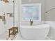 Luxurious bathroom featuring a standalone tub and glass-enclosed shower at 5015 Foxbriar Trl, Charlotte, NC 28269