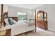 Well-lit bedroom with four-poster bed, dresser, and a neutral color scheme at 5015 Foxbriar Trl, Charlotte, NC 28269