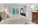 Bright bedroom featuring a dresser, large window, and neutral decor at 5015 Foxbriar Trl, Charlotte, NC 28269