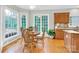 Bright breakfast nook featuring large windows and hardwood floors at 5015 Foxbriar Trl, Charlotte, NC 28269
