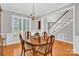 Elegant dining room showcasing hardwood floors, classic chandelier, and bright windows at 5015 Foxbriar Trl, Charlotte, NC 28269