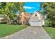 Lovely brick home boasts beautiful landscaping, an attached garage, and a welcoming driveway at 5015 Foxbriar Trl, Charlotte, NC 28269
