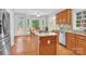 Spacious kitchen featuring granite countertops, stainless steel appliances, and hardwood floors at 5015 Foxbriar Trl, Charlotte, NC 28269
