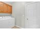 Convenient laundry room with washer, dryer, and storage cabinets at 5015 Foxbriar Trl, Charlotte, NC 28269