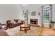 Cozy living room with fireplace and large windows at 5015 Foxbriar Trl, Charlotte, NC 28269