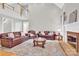 Spacious living room with high ceilings, fireplace, and leather sofas at 5015 Foxbriar Trl, Charlotte, NC 28269