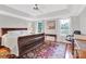 Inviting bedroom with tray ceiling, large windows, and hardwood floors at 5015 Foxbriar Trl, Charlotte, NC 28269