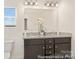 Bathroom featuring double sinks with granite countertops, modern fixtures, and a large mirror, combining style and functionality at 6017 Santee River Way # 40, Belmont, NC 28012