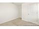 An empty bedroom showcases neutral walls, plush carpeting, and two doors providing ample closet space at 6017 Santee River Way # 40, Belmont, NC 28012