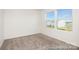 Bright bedroom features natural light from the window, neutral walls, and plush carpet flooring at 6017 Santee River Way # 40, Belmont, NC 28012