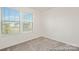 Bright bedroom features natural light from the window, neutral walls, and plush carpet flooring at 6017 Santee River Way # 40, Belmont, NC 28012