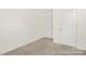 An empty bedroom showcases neutral walls, plush carpeting, and two doors providing ample closet space at 6017 Santee River Way # 40, Belmont, NC 28012