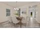 This bright dining room offers hardwood floors, modern chandelier lighting, views to the kitchen and a large window at 6017 Santee River Way # 40, Belmont, NC 28012