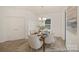 This bright dining room offers hardwood floors, modern chandelier lighting and has a connecting door to the kitchen at 6017 Santee River Way # 40, Belmont, NC 28012