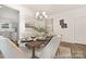 The dining room features hardwood floors, white walls and trim, and views to the kitchen and entryway at 6017 Santee River Way # 40, Belmont, NC 28012