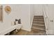 Inviting entryway featuring a stylish bench, storage, and a carpeted staircase at 6017 Santee River Way # 40, Belmont, NC 28012