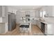 This bright kitchen features an island with barstool seating, stainless steel appliances, and stylish gray cabinets at 6017 Santee River Way # 40, Belmont, NC 28012