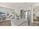 The kitchen features granite countertops and stainless steel appliances with an open view to the living and dining rooms at 6017 Santee River Way # 40, Belmont, NC 28012