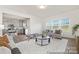 This open concept living room is connected to the kitchen and is filled with natural light from the large windows at 6017 Santee River Way # 40, Belmont, NC 28012