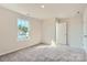 Sunny bedroom featuring large window, neutral paint, and carpet flooring at 6391 Fairfax Ct, Maiden, NC 28650