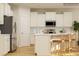 Bright kitchen boasts white cabinets, stainless appliances, backsplash, and center island with seating at 6448 Fairfax Ct, Maiden, NC 28650