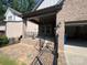 View of the back patio with brick flooring and a black iron railing at 707 Marion Dr, Matthews, NC 28105