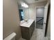 Modern bathroom vanity with neutral gray cabinets and a large framed mirror at 707 Marion Dr, Matthews, NC 28105