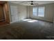 Bright carpeted bonus room features a ceiling fan and a wall of windows at 707 Marion Dr, Matthews, NC 28105