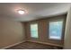 This bedroom features neutral walls, two windows bringing in natural light, and plush carpet at 707 Marion Dr, Matthews, NC 28105