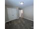 This bedroom features plush carpet, neutral paint, and closet space at 707 Marion Dr, Matthews, NC 28105