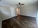 A spacious bedroom with hardwood floors, ceiling fan, a double door closet and crown molding at 707 Marion Dr, Matthews, NC 28105