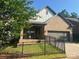 Beautiful brick home featuring a two-car garage, small porch, and well-kept front yard with a fence at 707 Marion Dr, Matthews, NC 28105
