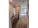Upstairs hallway with carpet and wood banister leads to a bedroom with natural light at 707 Marion Dr, Matthews, NC 28105
