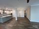 Bright and open kitchen featuring a large island with sink, stainless appliances, and hardwood floors at 707 Marion Dr, Matthews, NC 28105