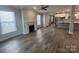Open-concept living space features hardwood floors, fireplace, and modern kitchen with stainless steel appliances at 707 Marion Dr, Matthews, NC 28105