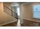 Living room with staircase featuring hardwood flooring and ample natural light at 707 Marion Dr, Matthews, NC 28105