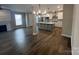 Open-concept living space with kitchen island, fireplace and hardwood floors at 707 Marion Dr, Matthews, NC 28105