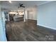 Living room features hardwood floors and adjoins an open kitchen with stainless appliances and center island at 707 Marion Dr, Matthews, NC 28105