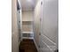 An interior mud room includes a bench seat, storage space, coat hooks and hardwood floor at 707 Marion Dr, Matthews, NC 28105
