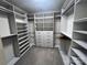 An organized walk-in closet with custom shelving, hanging racks, drawers, and carpeted floor at 707 Marion Dr, Matthews, NC 28105