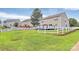 Large grassy backyard with a deck and white picket fence at 902 Silverberry St, Gastonia, NC 28054