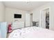 Bright bedroom featuring a television, neutral walls, and an adjacent walk-in closet at 902 Silverberry St, Gastonia, NC 28054