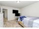 Well-lit bedroom features neutral carpet and a large television at 902 Silverberry St, Gastonia, NC 28054