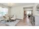 Elegant dining room with stylish chandelier, round glass table, and hardwood floors at 902 Silverberry St, Gastonia, NC 28054