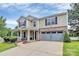Inviting two-story home with manicured lawn, brick and siding exterior, and attached two-car garage at 902 Silverberry St, Gastonia, NC 28054