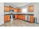This eat-in kitchen features natural wood cabinets, stainless appliances, and durable granite countertops at 902 Silverberry St, Gastonia, NC 28054