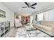 This great room features neutral paint, mirrored accents, and flows into the kitchen and dining area at 902 Silverberry St, Gastonia, NC 28054
